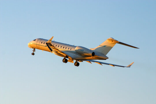 Luqa, Malta - July 16, 2005: Bombardier BD-700-1A10 Global Express (REG: N700KS) taking off in the last rays of the sun.