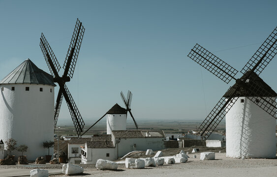 Castilian Landscape With Traditional Windmills and Small White Houses Under Blue Sky