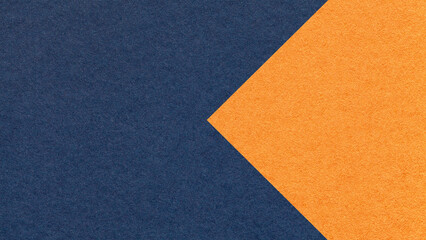 Fototapeta premium Textured dark blue paper background with orange arrow, macro. Template with copy space for banner, presentation