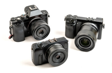 Fototapeta premium Three Older Mirrorless Cameras With Prime Lenses