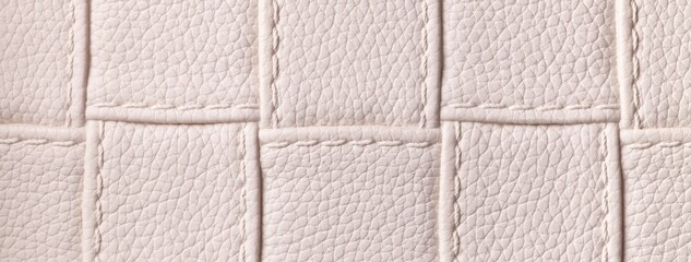 Fototapeta premium Texture light beige leather background with quilted stitched pattern, macro. Abstract pastel nude upholstery surface