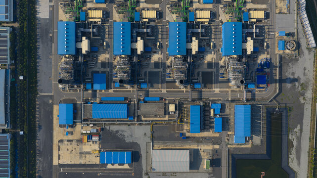 Aerial view of the Gulf PD Power Plant industrial complex with blue-roofed buildings and cooling towers in Map Yang Phon, Rayong, Thailand.