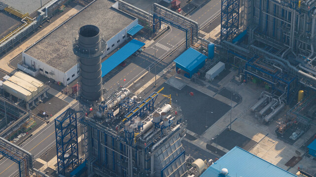 Aerial view of the Gulf PD Power Plant featuring industrial chimneys, complex steel structures, and blue-roofed buildings Map Yang Phon, Rayong, Thailand.