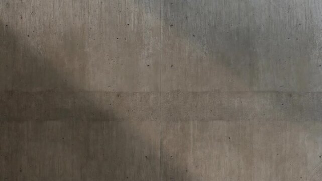 Concrete wall with subtle shadows in a realistic photographic style on a plain background, concept of minimalism and texture