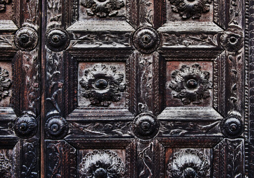 Close up of the Renaissance-era carved wooden portal of the Parma Cathedral (Duomo di Parma). carved in 1494 by Luchino Bianchino (also documented as Luchino de' Bonati), Parma, Italy, Europe