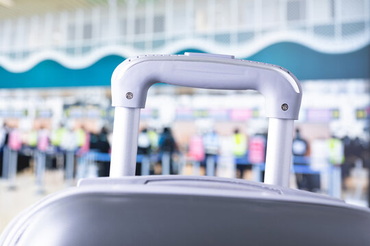 travelling suitcase, luggage or travel bags at airport terminal