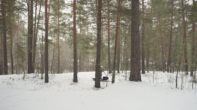 ATV swiftly races icy forest. Rapid ATV acceleration navigating icy pine forest terrain with skill. Energetic ATV journey cutting through snowy woods filled with pine trees and excitement