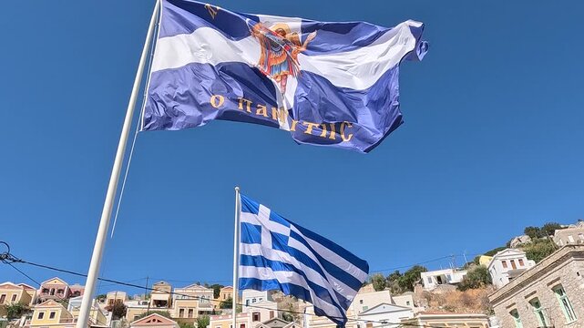 The waving Greek flag and the flag of Simi Island. Rhodes, Greece