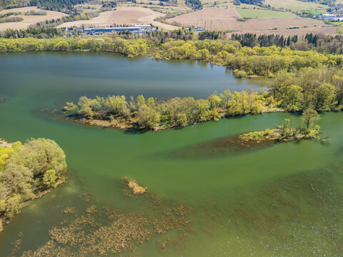 Aerial view of Biela Orava river with lush green islands and surrounding vegetation Namestovo, Zilinsky kraj, Slovakia.