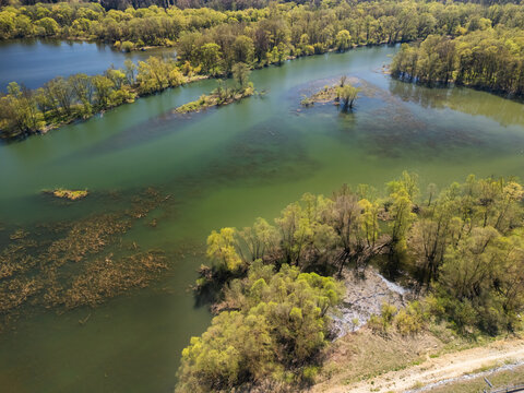 Aerial view of the Biela Orava river featuring lush green trees and small islands in Namestovo, Zilinsky kraj, Slovakia.