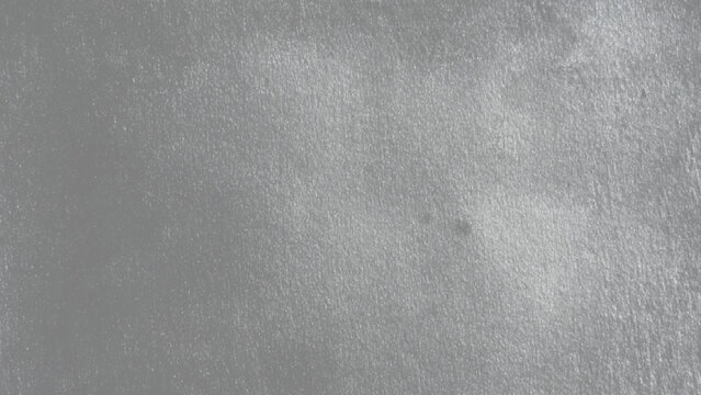 Gray rough textured surface with small specks and slight sheen detailed closeup