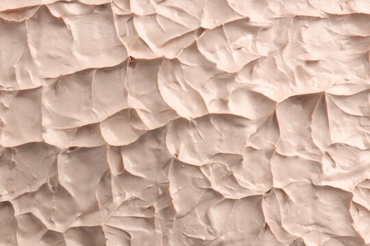 Natural clay paste for facial and body care as background, top view. Mud therapy