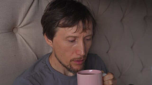 Man drinking hot tea, blowing to cool it and sipping with loud sounds, high quality uncompressed audio recording. Cozy everyday moment, beverage enjoyment and realistic lifestyle concept.