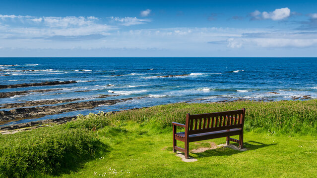 Un banc vide face &agrave; la mer du Nord sous le ciel bleu &agrave; c&ocirc;t&eacute; de Brough of Birsay, orcades, Ecosse