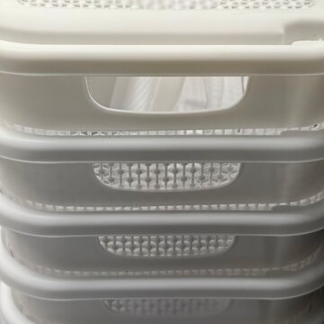 Stacked White Plastic Laundry Baskets with Patterned Ventilation