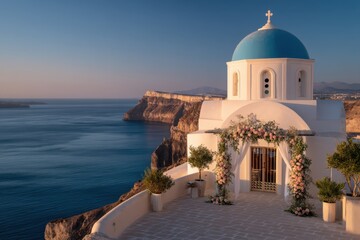 Obraz premium A white-domed church in Santorini stands against the sea, warmly lit and decorated for a romantic Mediterranean wedding.