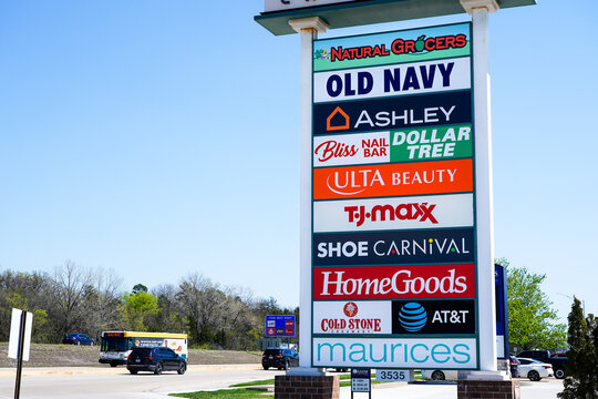 Plaza sign listing stores including Natural Grocers, Old Navy, Ashley, Dollar Tree, Ulta Beauty, T.J. Maxx, Shoe Carnival, Cold Stone Creamery, and AT&T in Jefferson City, Missouri, April 2026