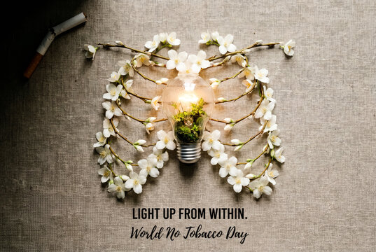 Postcard for World No Tobacco Day showing floral lungs and light bulb text Light Up From Within.