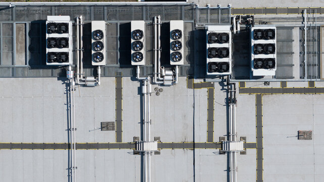 Aerial view of industrial HVAC units with large fans and complex piping on a flat rooftop in Utrecht, Utrecht, Netherlands.