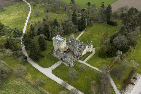 Aerial view of Drum Castle Garden and Estate National Trust for Scotland featuring the historic stone tower and surrounding green lawns Drumoak, Scotland, United Kingdom.