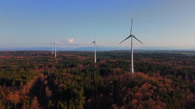 Wind farms in Landkreis Starnberg, Germany, filmed from above during clear weather. Utility scale turbines and Enercon E-115 systems generate green electricity and renewable power.