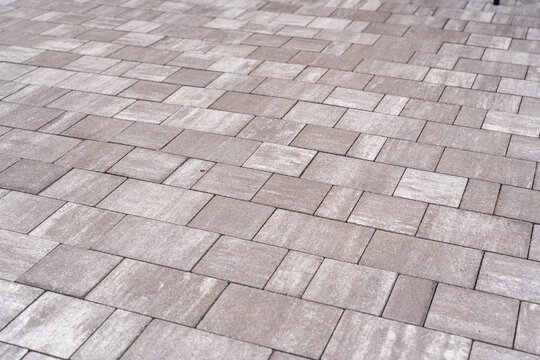 Textured gray pavers arranged in a geometric pattern, ideal for landscaping and outdoor design projects, providing a modern and durable surface
