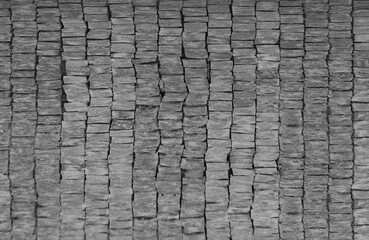 Fototapeta premium Front view of a wall made of gray slabs. background of a new and modern wall or building exterior grey slabs Marble brick pattern floor abstract natural marble black gray wall Top view and front view
