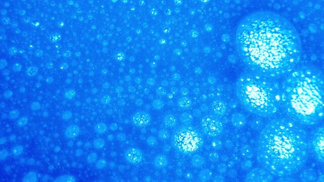 close up of soap bubbles in water. abstract background for cleaning liquid ads or chemical reactions.