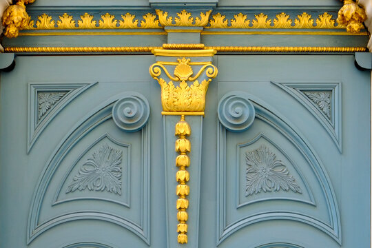 Blue door with gold classical ornament detail