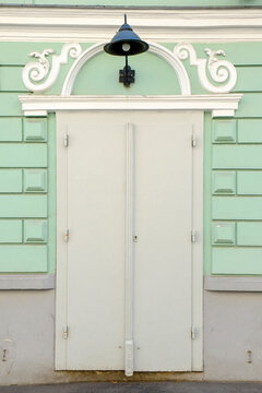 Pale green facade with simple white door