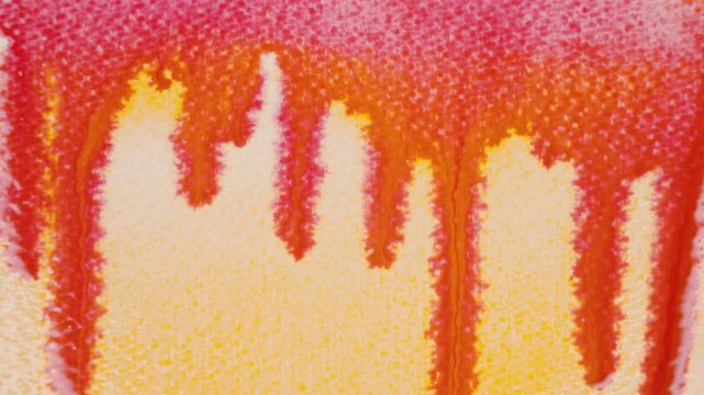 Close up of orange watercolour drawing paints on paper. Artist draws with a brush, liquid analog effects for background with copy space for text in center. 