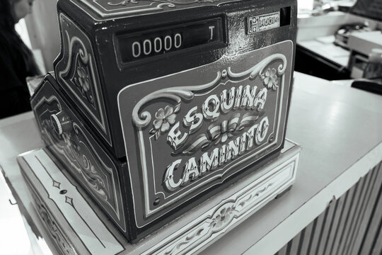 Ornately decorated vintage cash register captures traditional fileteado art and historical charm. 