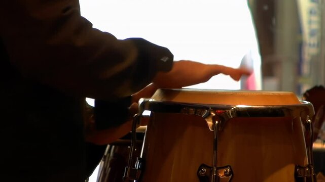 Detail of musician performing rhythmic beats on percussion instrument