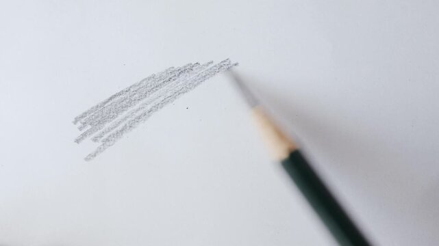 close up of graphite pencil drawing on textured paper. slow motion footage. Background video can be used as overlay. doodling hatching