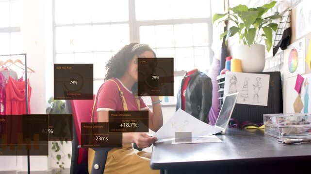 Woman phoning flipping sketches glancing laptop fashion data starting metric boxes stacking on desk