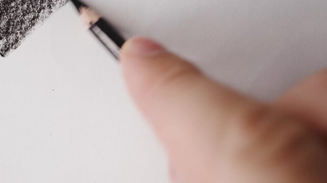 close up of charcoal pencil drawing on textured paper. slow motion footage. Background video can be used as overlay. doodling hatching
