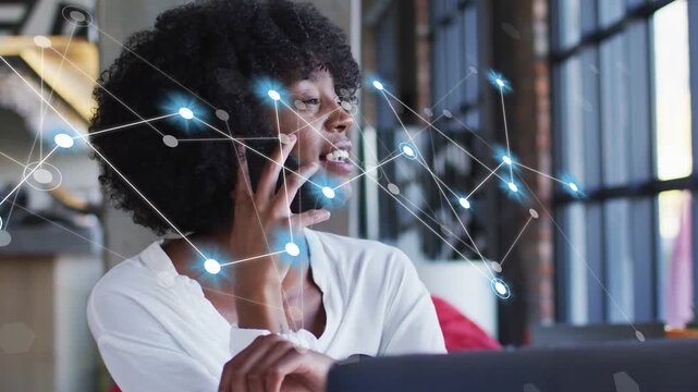 Woman taking call then using smartphone, network nodes growing over laptop, enabling tech teamwork