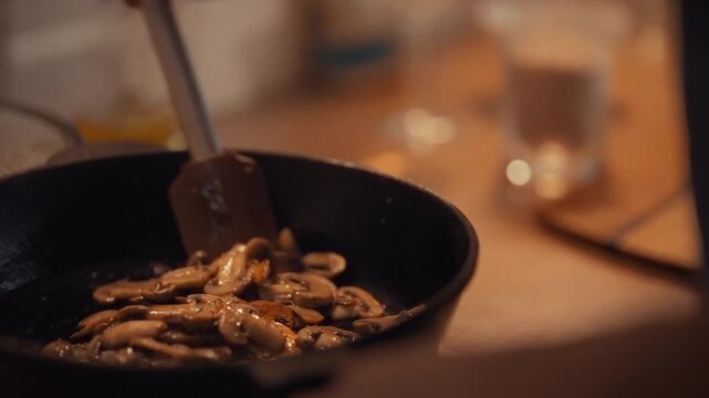 Inside bustling kitchen, chef-man sautes fresh champignons in hot pan, the sizzling mushrooms releasing earthy aromas as he skillfully cooks, the clatter of pans and warm light highlighting the scene