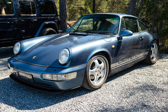 Djurhamn, Sweden - May 10, 2026: Classic Metallic Blue Porsche 911 Carrera 964 Coupe as seen at car exhibition
