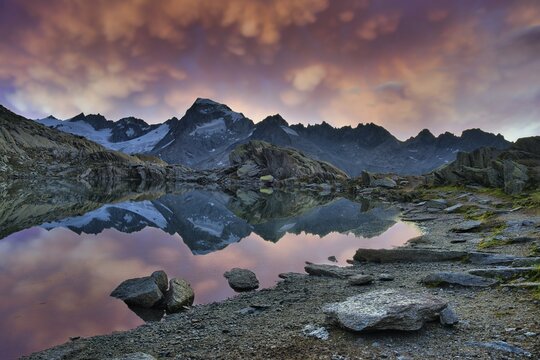 Gr&auml;tlisee, canton of Valais, with reflection of the mountains, thunderclouds over Mount Galenstock, canton of Uri, Switzerland