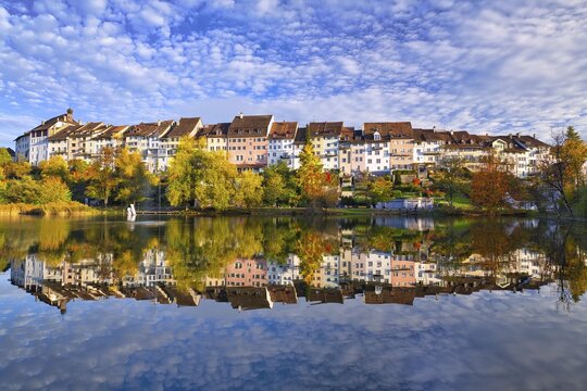Local view of the old town of Wil in autumn, reflection of the old houses and the atmospheric clouds in the sky in the pond of the town park, Canton St. Gallen, Switzerland