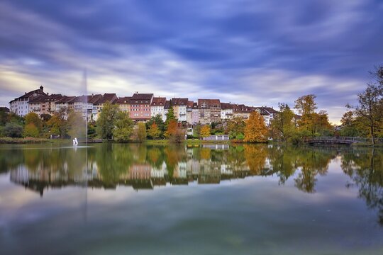 Reflection of the old town of Wil in the pond of the municipal park, thunderclouds at the blue hour, Canton St. Gallen, Switzerland