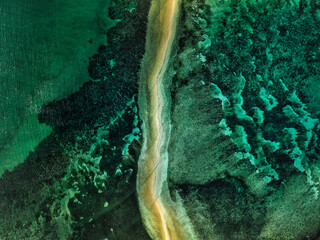 Aerial drone view of Lakdayan Sandbar near Coron Island, Philippines, featuring a curved tropical sandbar, turquoise coral reefs, crystal clear ocean water and a remote island landscape in Palawan. © akturer