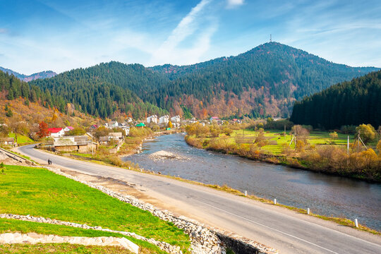 mountain landscape during fall season. rural scenery of transcarpathia with rika river in the afternoon light. picture of a countryside road through valley near soimy village for travel background
