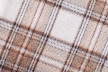 Diagonal plaid blanket texture in beige and brown tones with soft wool surface, cozy textile background for winter concepts, fashion materials, home decor and abstract design © svittlana