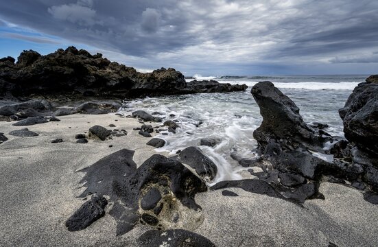 Waves blaze on the beach, rocky coast with volcanic stones, long exposure, Playa de la Peque&ntilde;a, Punta Usaje, Lanzarote, Canary Islands, Spain
