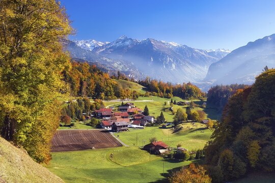 View of the autumn-colored Hasli Valley, Br&uuml;nigen hamlet near Meiringen behind Uri Alps, Canton of Bern, Switzerland