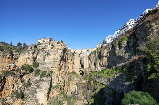 Bridge Puente Nuevo with waterfall at steep cliffs, Tajo gorge and river R&iacute;o Guadalev&iacute;n, Ronda, province of Malaga, Andalusia, Spain