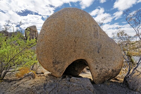 Round shaped huge granite rock with an erosed hole, Split Rocks, Joshua Tree National Park, Desert Center, California, USA