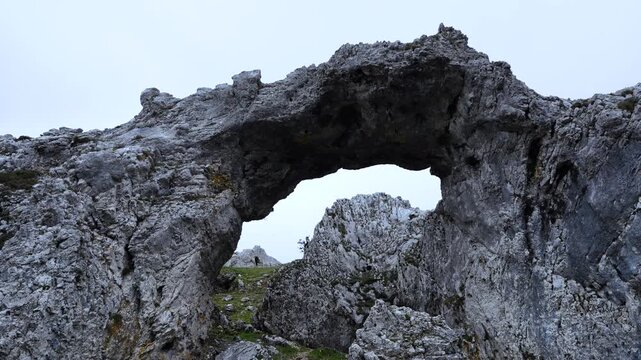 Stone Arch of Urbasa near the Lizarraga Pass in the Andia Mountains. Urbasa and Andia Natural Park. Navarre. Spain. Europe